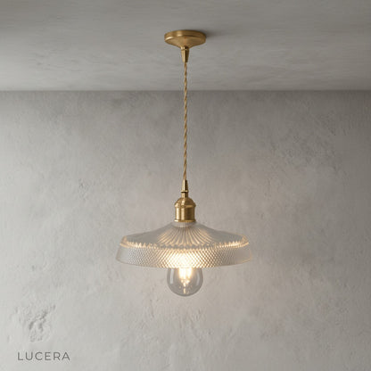 Harmony Pendant Light in vintage brass finish hanging over rustic wooden kitchen island