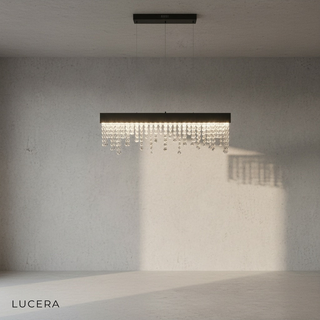 Sol chandelier with warm LED light over a wooden dining table in an open-plan space