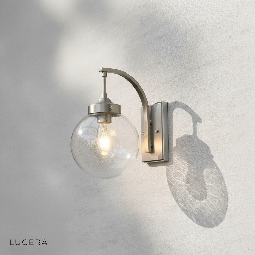 Nyx outdoor wall light with E27 bulb visible through transparent glass shade