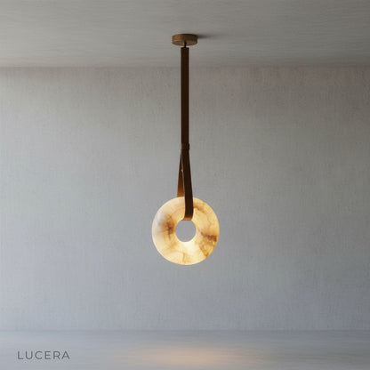minimalist studio view of Lucera Butte pendant light showing warm alabaster texture