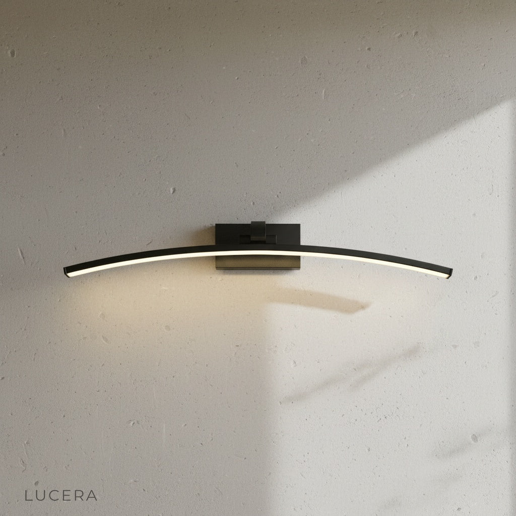 ginkgo wall lamp in brushed gold finish mounted on textured plaster wall