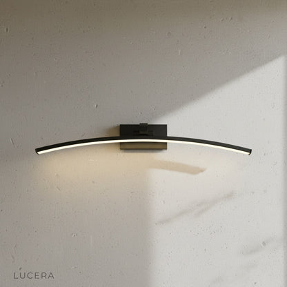 ginkgo wall lamp in brushed gold finish mounted on textured plaster wall