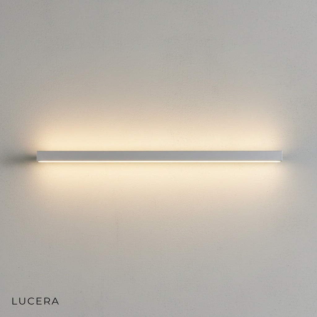 Staccato Bookshelf LED Wall Lamp in matte black finish mounted above a wooden bookshelf