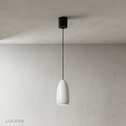 three capsule pendant lights in different metallic finishes arranged in a row