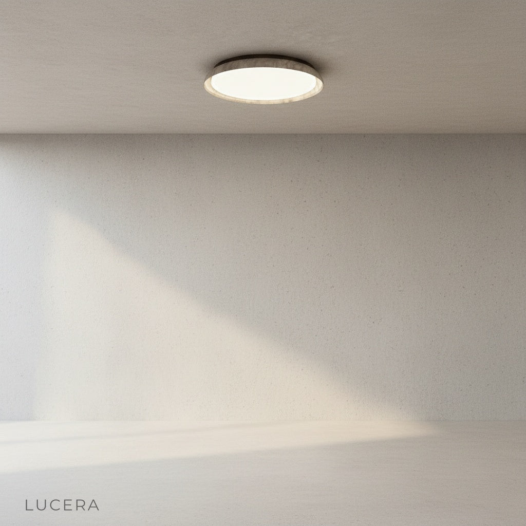 Close-up of travertine texture and warm glow on Eau de Vie ceiling light