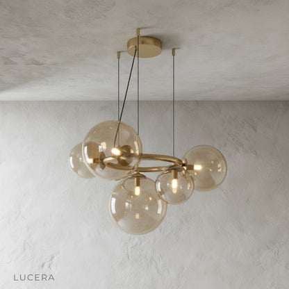 Grenache chandelier with clear glass orbs and brushed gold metal ring