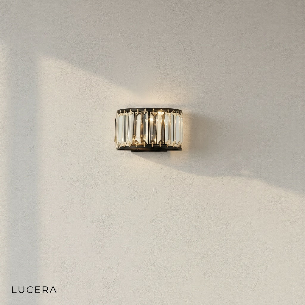 gold Fermata wall light with crystals glowing at dusk in luxury bedroom setting