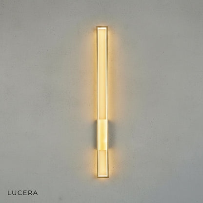 close-up of copper-toned metal frame and acrylic shade texture on modern wall sconce