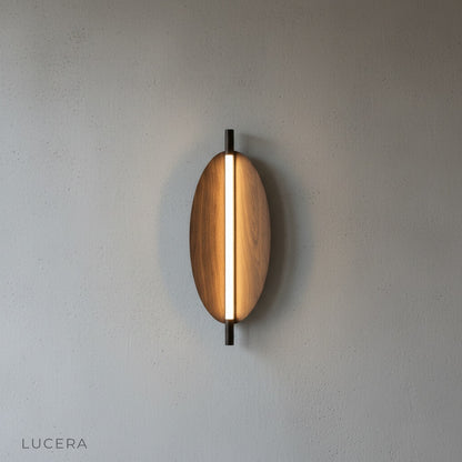 Rise sconce in warm ambient light casting even illumination on textured plaster wall