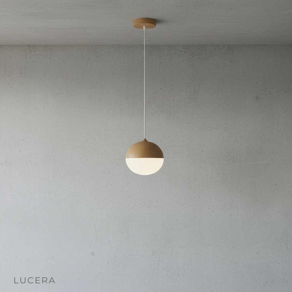 Holly pendant light with adjustable cord hanging above a kitchen island in modern home
