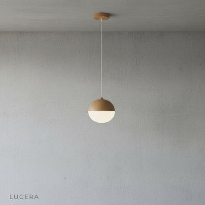 Holly pendant light with adjustable cord hanging above a kitchen island in modern home