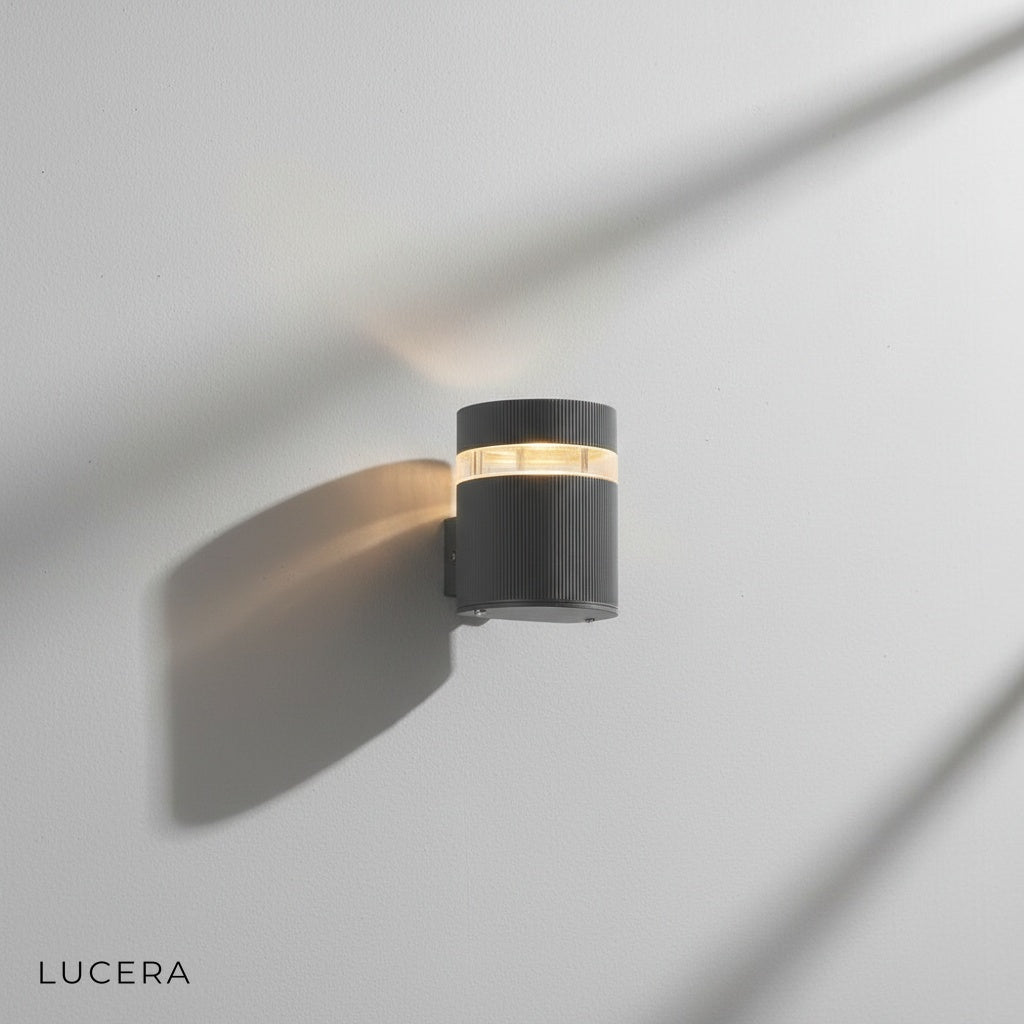 Reese outdoor wall lamp in cool white light against textured concrete garden wall