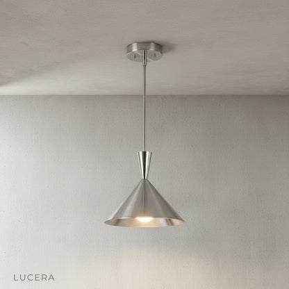 Cairn pendant light hanging in a cozy reading nook with a warm afternoon glow