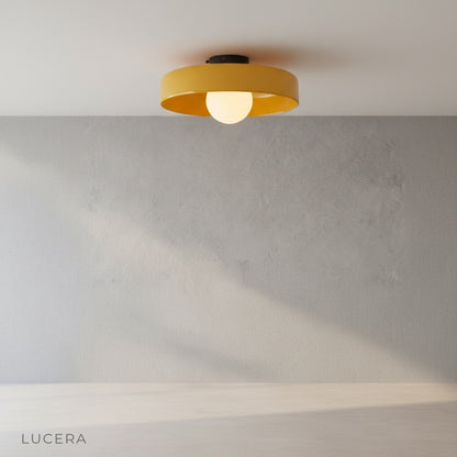 Madder ceiling light in a bright office corner, minimalist design casting warm glow over a wooden desk