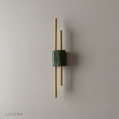 Close-up of Xyloid wall lamp LED light source with warm glow and brushed metal texture