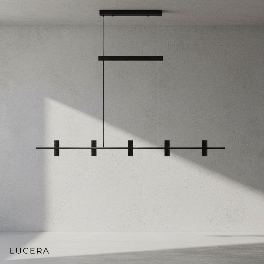 Black copper and stone chandelier hanging in bright neutral bedroom with soft daylight