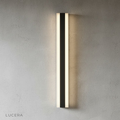 Drambuie wall lamp angled view highlighting slim profile against neutral gray wall