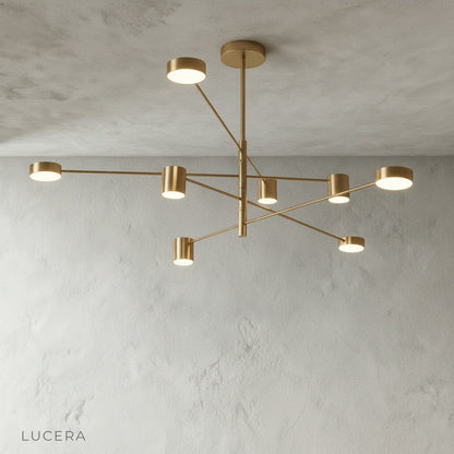 Winsor Blue Chandelier illuminated with warm bulbs in a minimalist studio setting