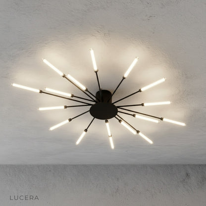 close-up of Karma chandelier LED bulbs and brushed metal connectors against dark backdrop