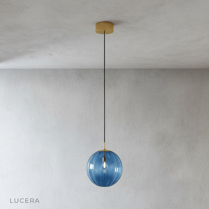 Tramonto pendant light with warm LED glow casting colorful patterns on a kitchen island