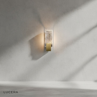Slargando wall light in stairway corridor casting sparkling reflections on wall