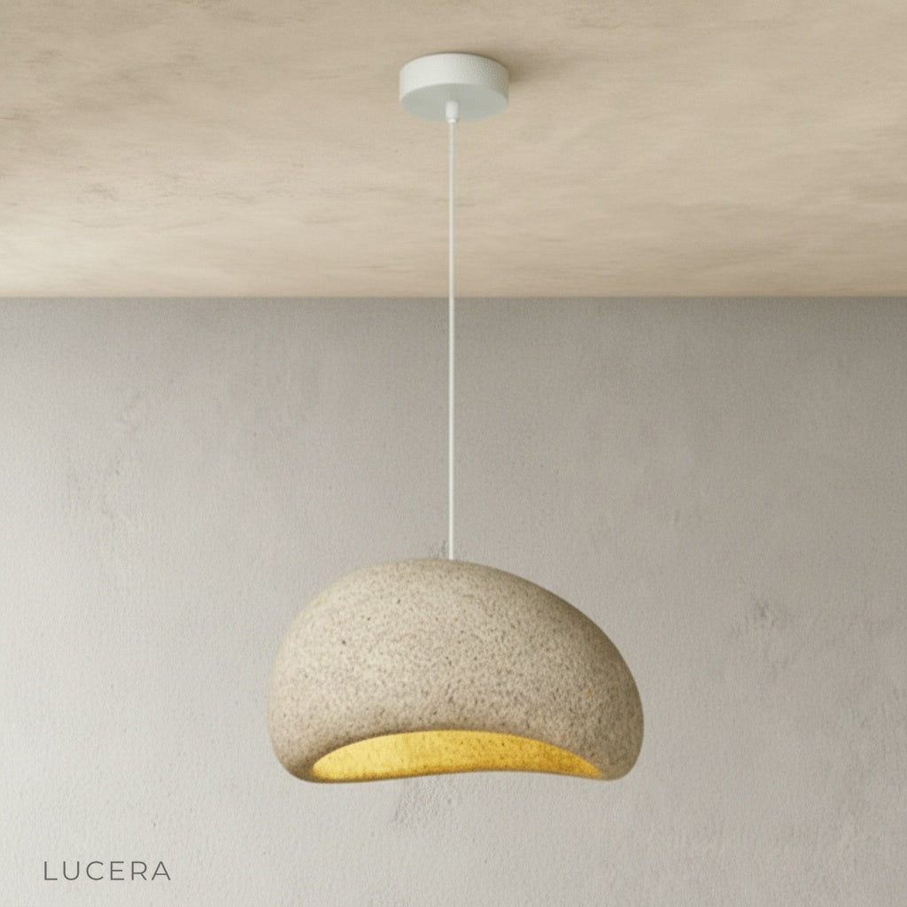 suite sand pendant light hanging above kitchen island with bar stools