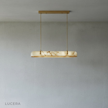 Nerissa chandelier in a kitchen island setting with warm ambient lighting and wooden stools