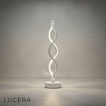 Warm glow of spiral LED table sconce on bedside table in cozy bedroom at dusk