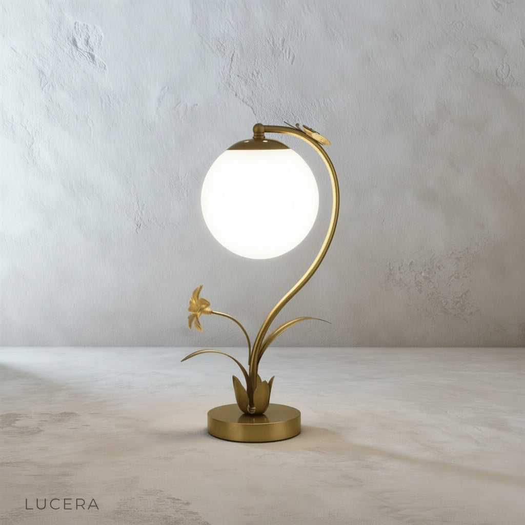 Close-up of Domenica Table Lamp base with faux flowers and butterfly, textured metal finish