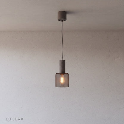 Ridge Pendant Light in matte black finish suspended in a bright kitchen island setting with contemporary stools