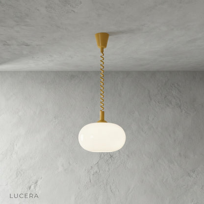 Xanthous pendant light at mid-height in bright living room with neutral decor
