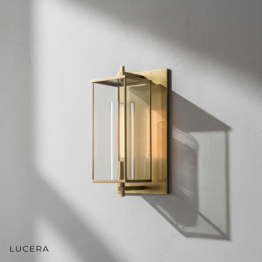 Detail shot of the clear glass globe and polished brass fixture of the Ariel lamp