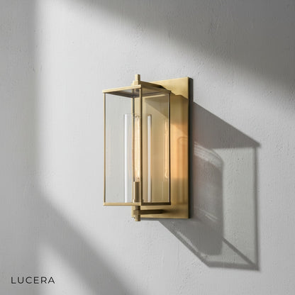 Detail shot of the clear glass globe and polished brass fixture of the Ariel lamp