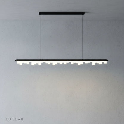 Lucera pendant light with dynamic skyline design casting warm ambient glow in a stylish living room