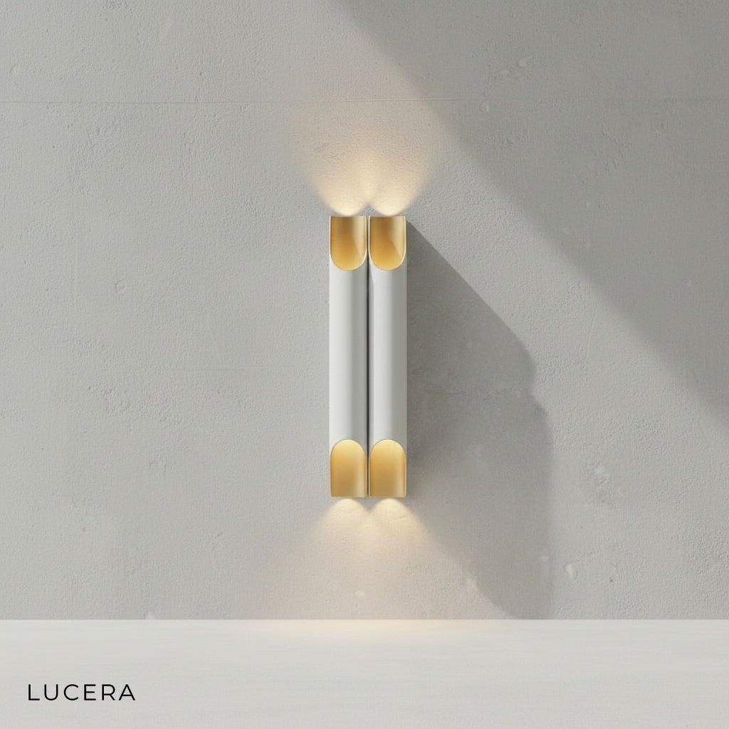 Crema LED wall lamp in white gold finish styled above a minimalist console table in a chic entryway