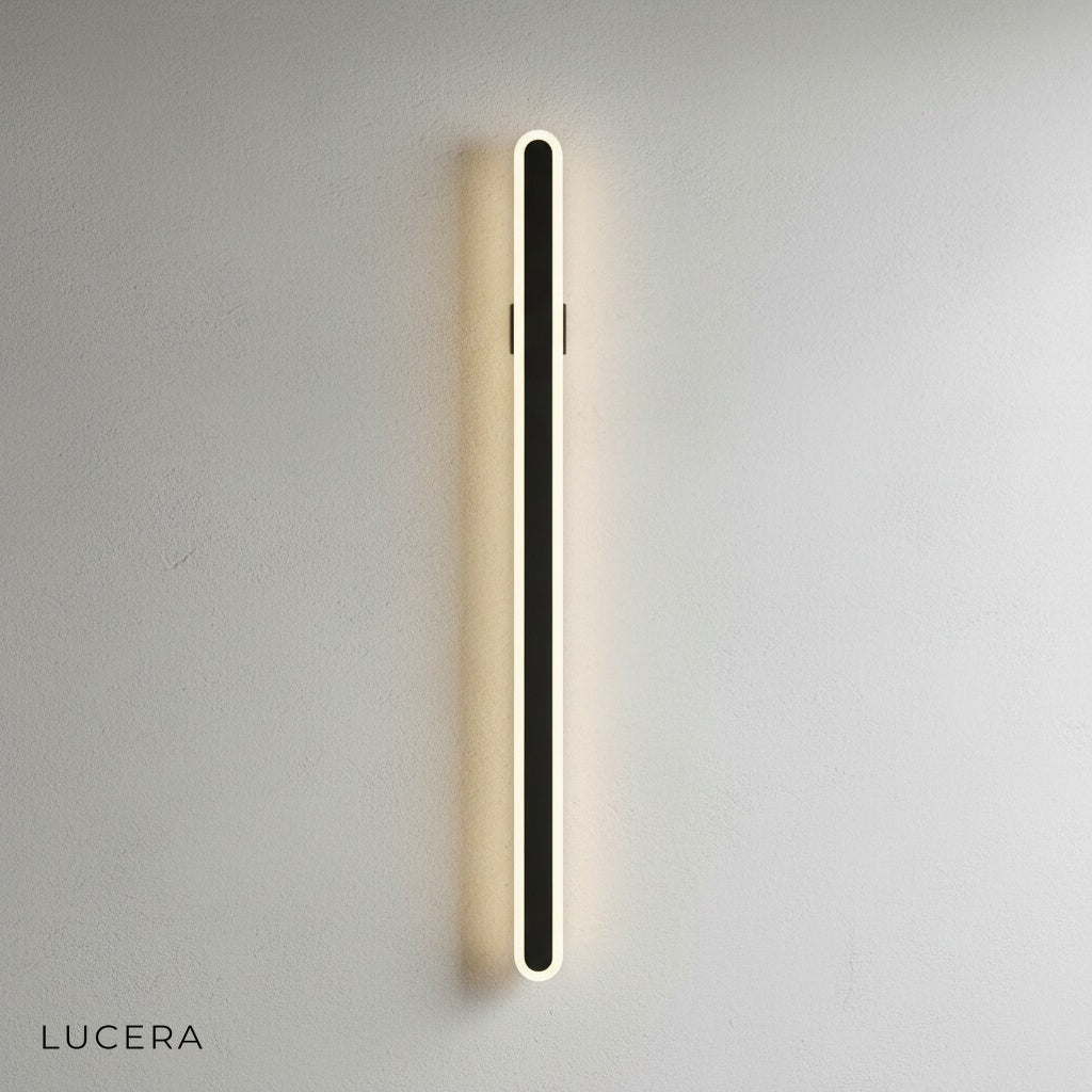 Diminuendo minimalist wall lamp above bedroom nightstand casting gentle light
