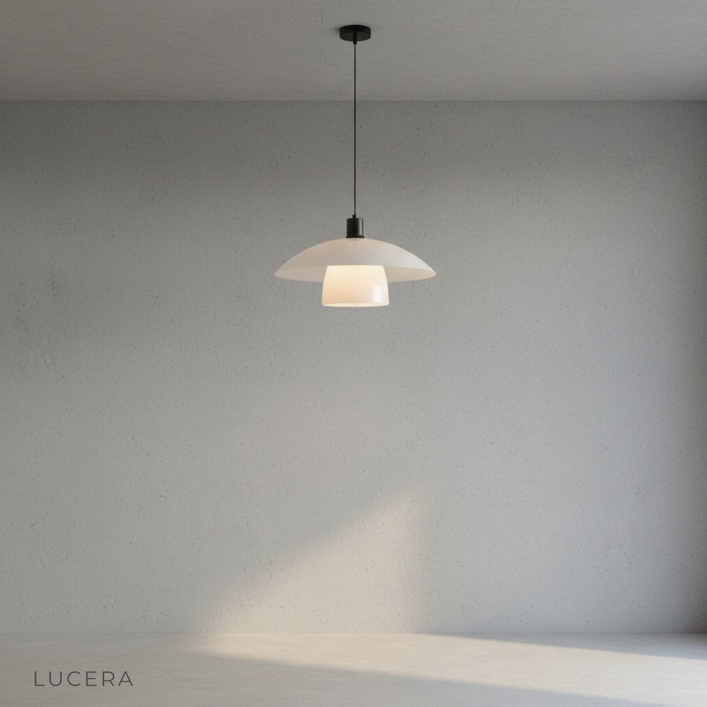 Eburnean pendant light casting soft ambient glow in entryway with neutral wall