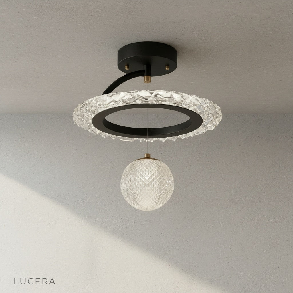 Xyle ceiling light in gold finish with warm ambient glow against white wall