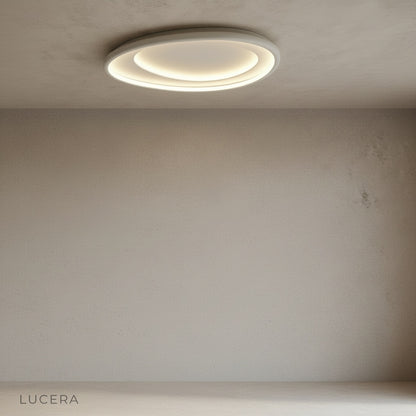 Tantalus ceiling light suspended over dining table with warm ambient light