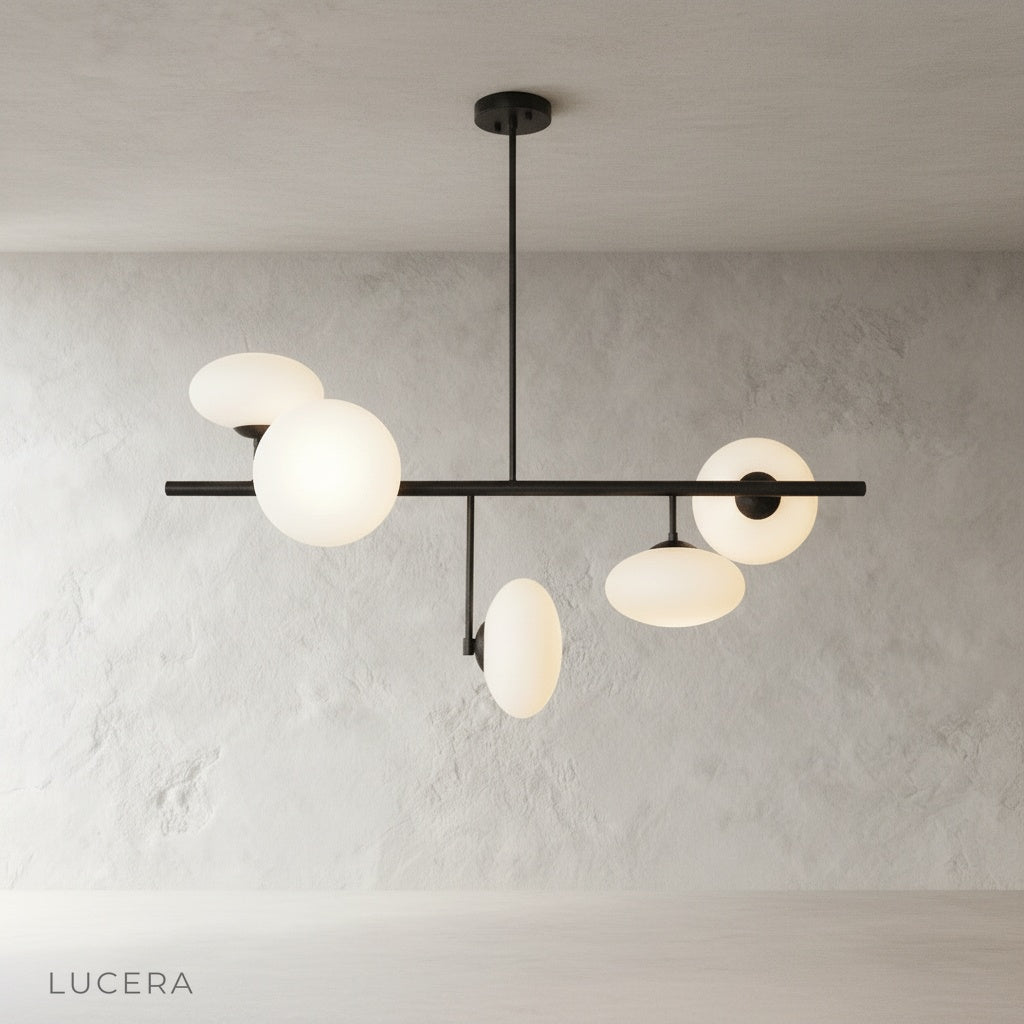 Naples Yellow Chandelier angled studio view highlighting sculptural brass structure