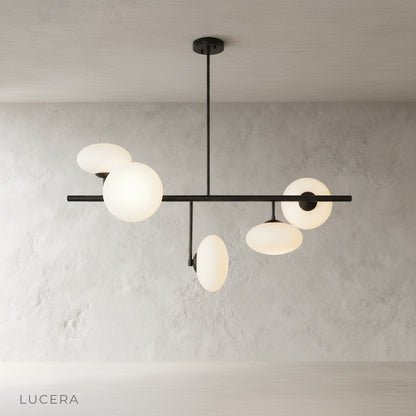 Naples Yellow Chandelier angled studio view highlighting sculptural brass structure