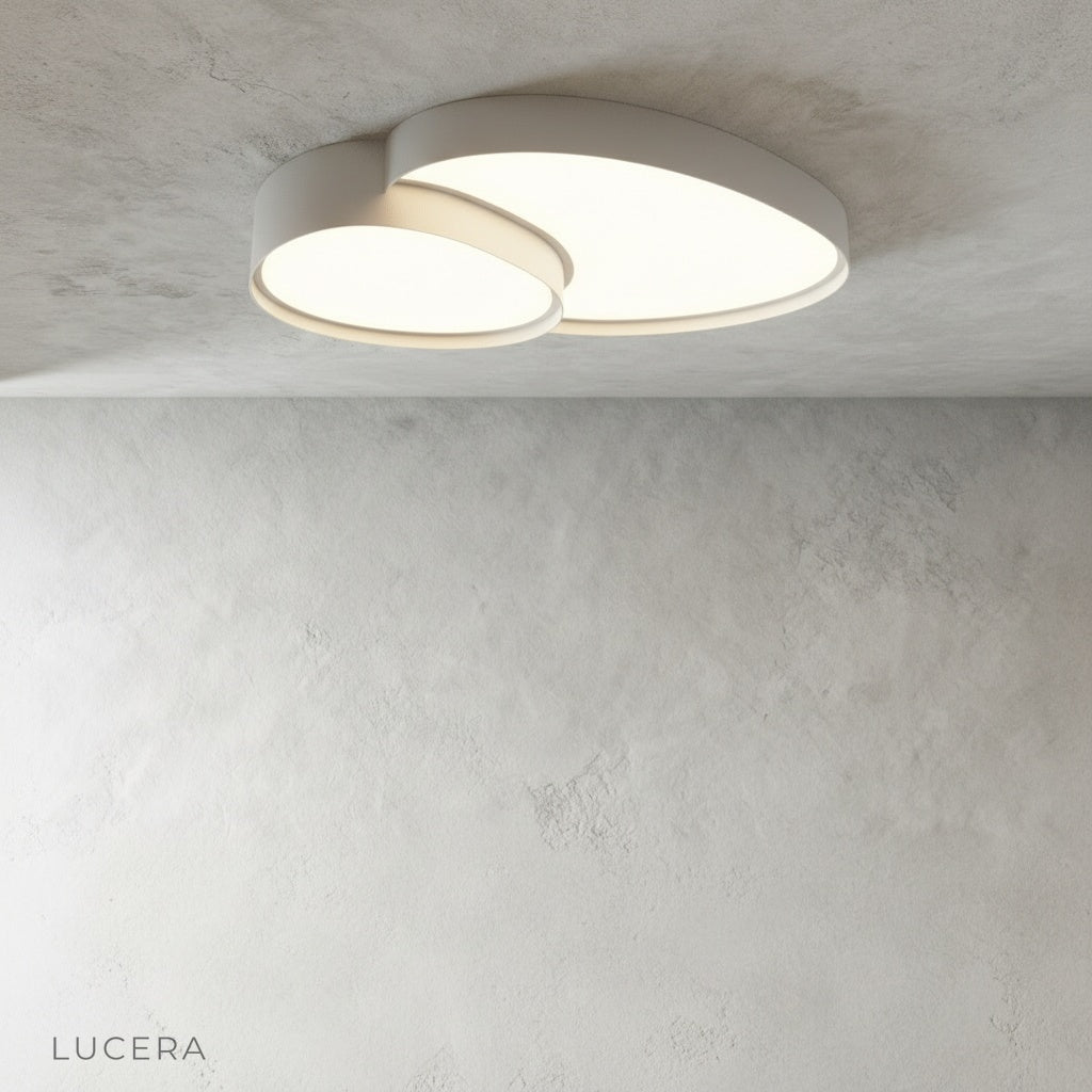 Yielding ceiling light in cool daylight mode above a contemporary living room sofa