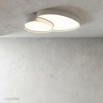 Yielding ceiling light in cool daylight mode above a contemporary living room sofa