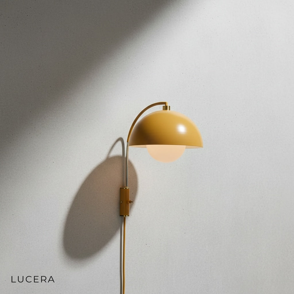 Coronal Nordic wall lamp above bedside table in warm bedroom setting