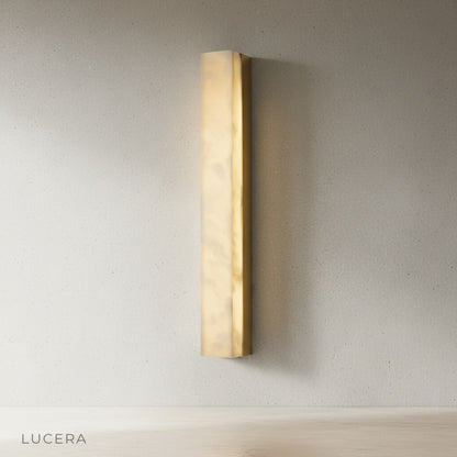 Dara sconce mounted above wooden console table in cozy neutral living room