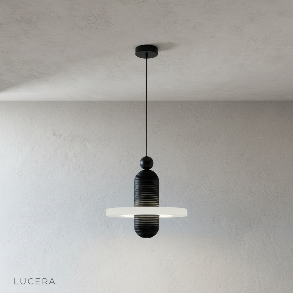 Marianist pendant light hanging at adjustable wire length in minimalist studio