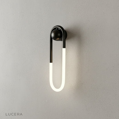 Ximena Wall Lamp illuminating cozy bedroom nightstand at dusk