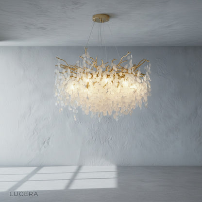 gold chandelier with crystal cascade above dining table