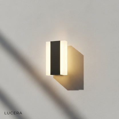 cool white light version of the outdoor sconce on a wooden deck wall