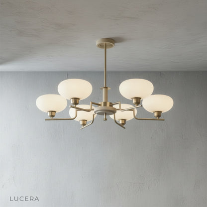 walnut and brass accent detail on curved chandelier arm with warm ambient glow